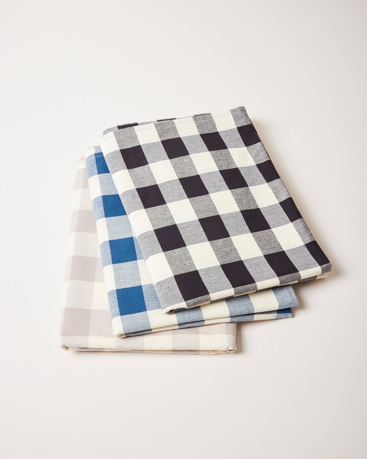Farmhouse Pottery farmers gingham tablecloths stacked shot with black navy and grey.