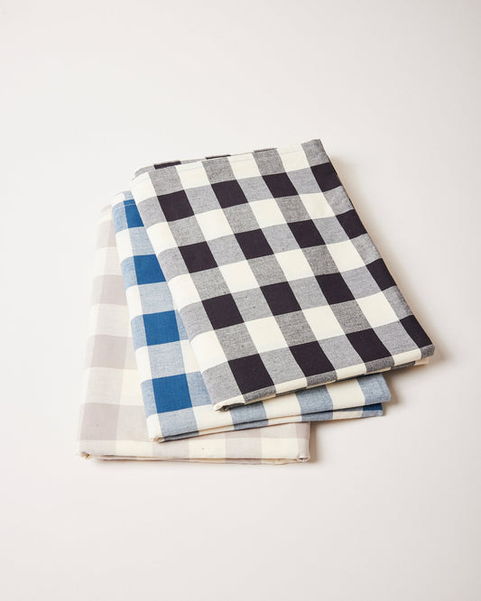 Farmhouse Pottery farmers gingham tablecloths stacked shot with black navy and grey.